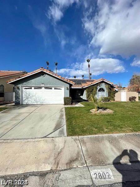 ranch-style home with a front yard and a garage