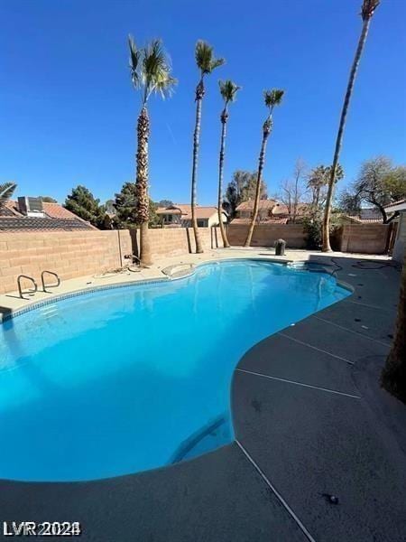 view of swimming pool with a fenced in pool and a fenced backyard