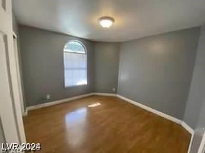 unfurnished bedroom featuring baseboards and wood finished floors