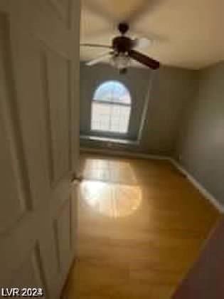 bonus room with baseboards and a ceiling fan