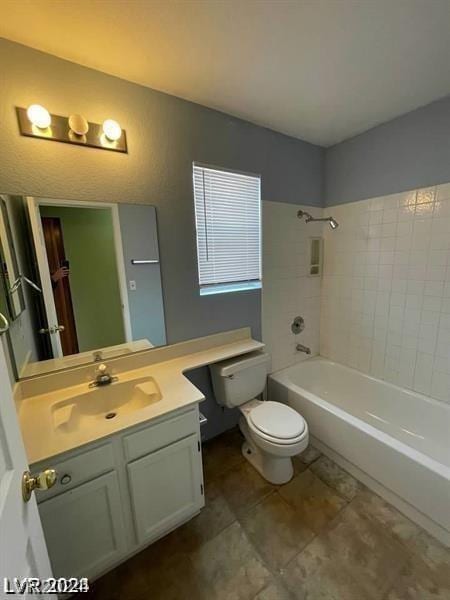 bathroom featuring toilet, bathtub / shower combination, and vanity