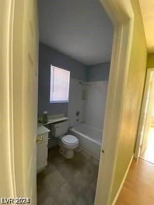 bathroom featuring vanity, shower / bathing tub combination, and toilet