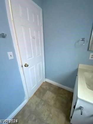 bathroom with vanity and baseboards