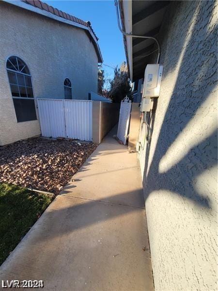 view of side of property with stucco siding and a tiled roof