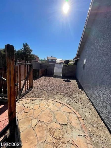 view of patio with a gate and fence