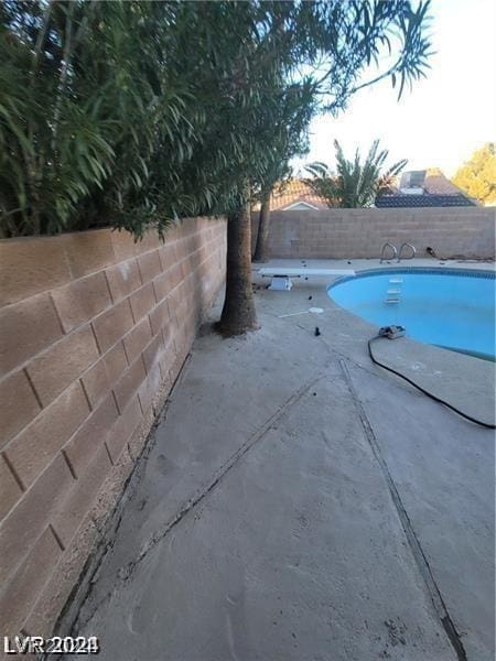 view of pool with a patio area, a fenced in pool, and a fenced backyard