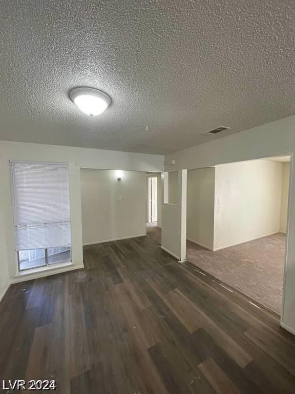 interior space with carpet and a textured ceiling