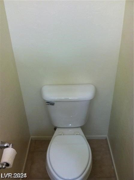 bathroom with toilet and tile patterned floors