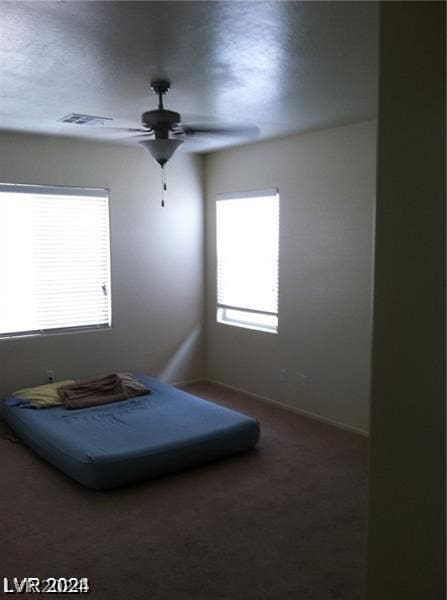 bedroom with ceiling fan and carpet flooring