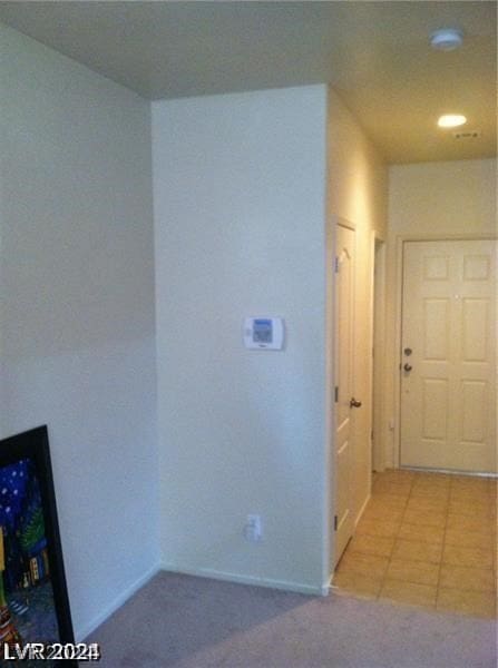 hallway featuring light tile patterned floors