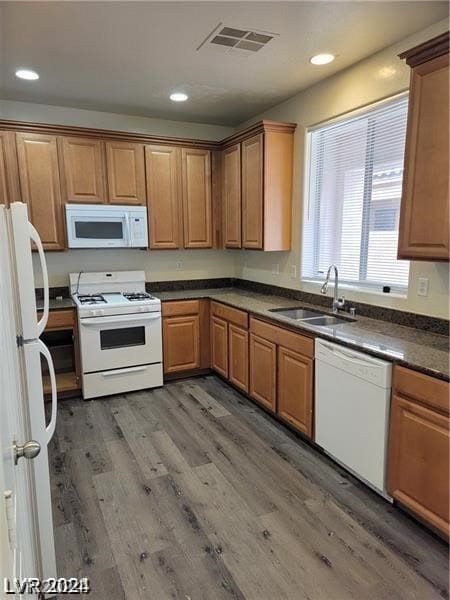 kitchen with sink, hardwood / wood-style floors, and white appliances