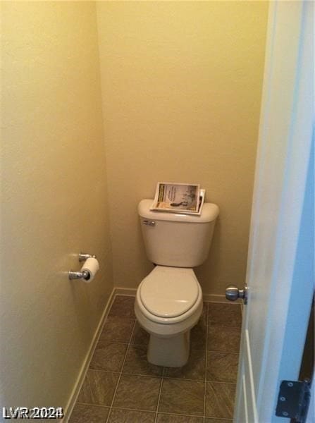 bathroom with toilet and tile patterned floors