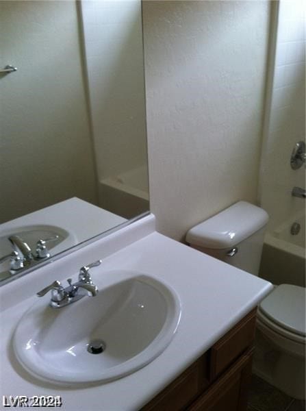 full bathroom with vanity, toilet, and washtub / shower combination