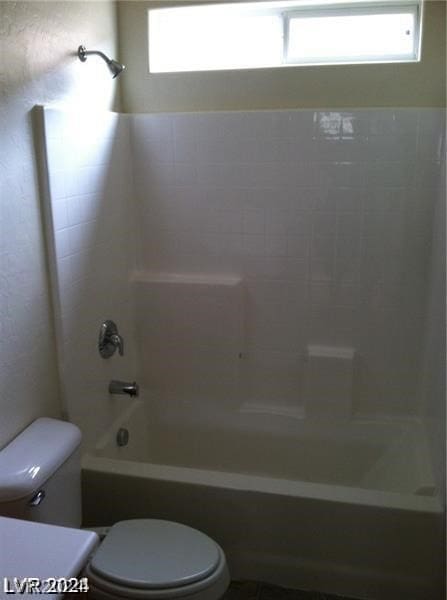 bathroom featuring tub / shower combination and toilet