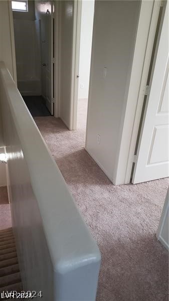 hallway with light colored carpet