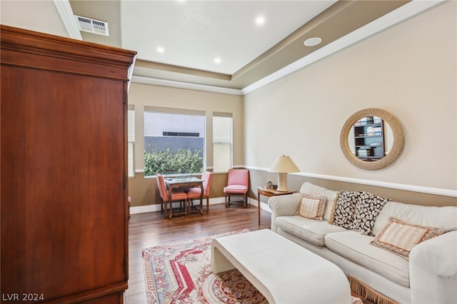 living room featuring ornamental molding and dark wood-type flooring