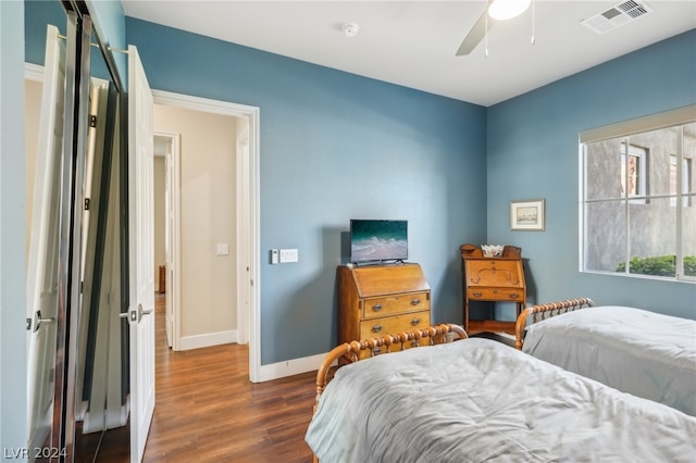 bedroom with dark wood-type flooring and ceiling fan