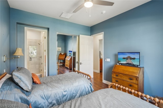 bedroom with dark wood-type flooring, ceiling fan, and connected bathroom