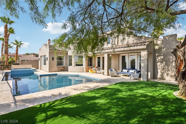 back of house featuring an outdoor hangout area, a lawn, and a patio area