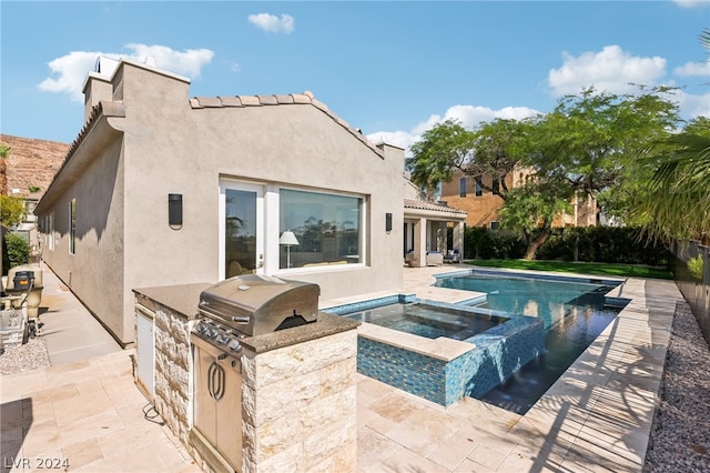 view of pool with area for grilling, a patio, and an in ground hot tub