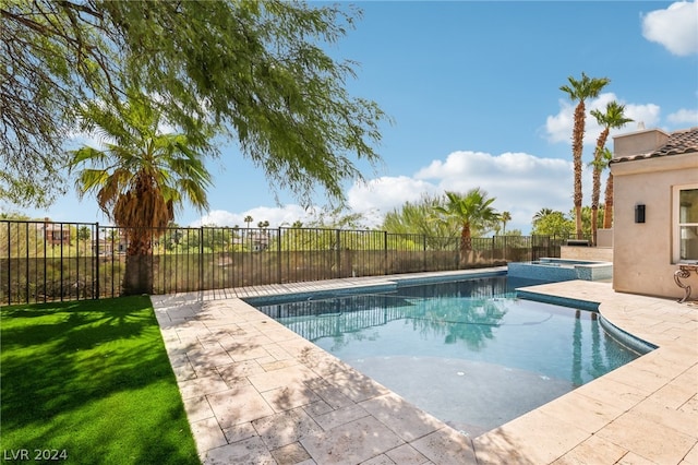 view of swimming pool featuring a yard and a patio area