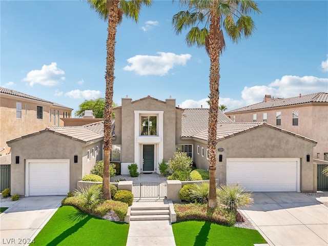 mediterranean / spanish-style home with a garage