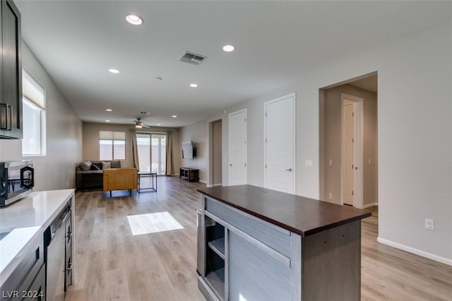 kitchen with ceiling fan, light hardwood / wood-style floors, a center island, and dishwasher