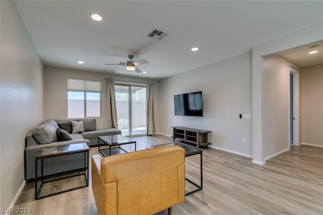 living room featuring ceiling fan and light hardwood / wood-style flooring