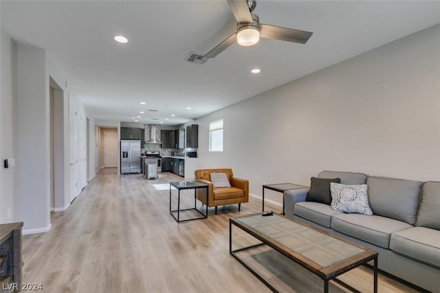 living room with ceiling fan and light hardwood / wood-style floors