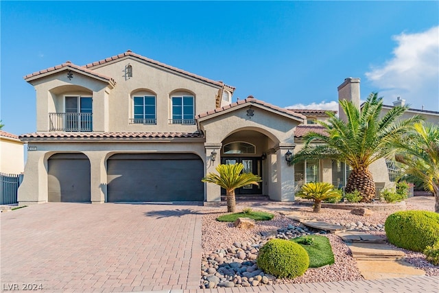 mediterranean / spanish house featuring a garage