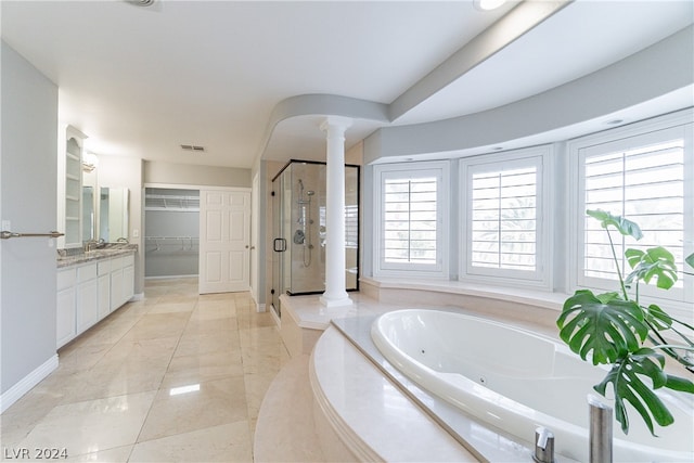 bathroom with vanity, separate shower and tub, and ornate columns