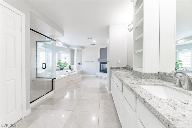 bathroom with vanity, plus walk in shower, and a multi sided fireplace