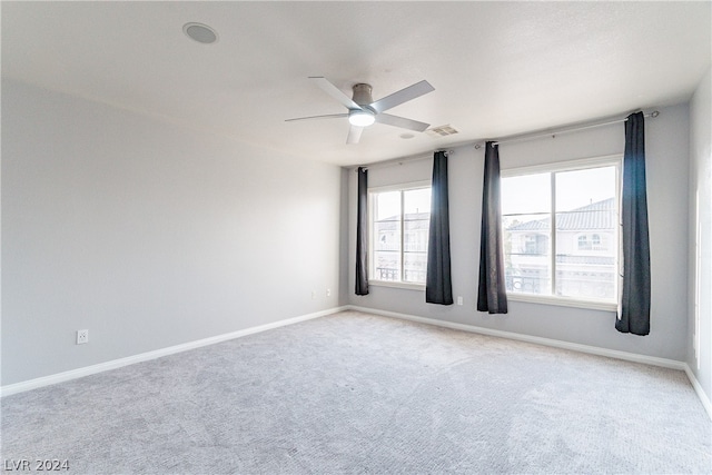 empty room featuring light carpet and ceiling fan