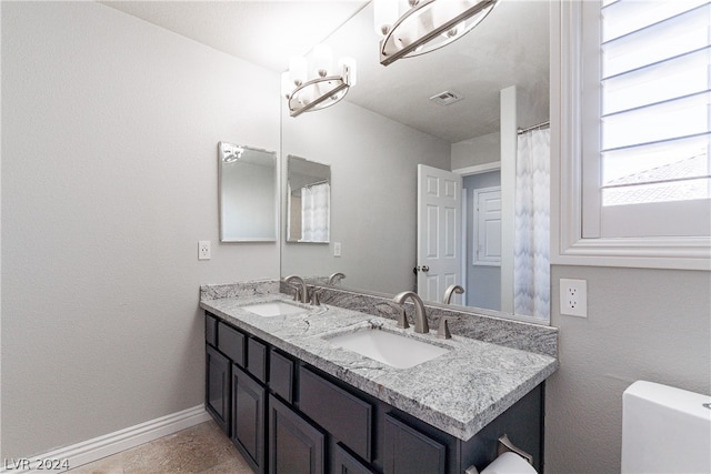 bathroom with toilet and vanity