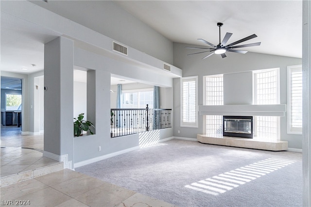 unfurnished living room with a fireplace, light carpet, lofted ceiling, and ceiling fan