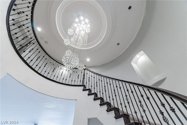 stairs with a chandelier