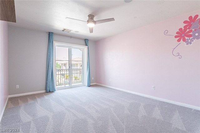 carpeted spare room featuring ceiling fan