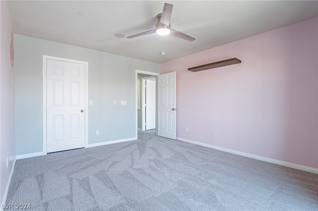 unfurnished bedroom featuring light carpet and ceiling fan