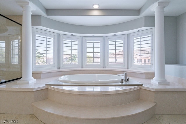 bathroom featuring plenty of natural light, plus walk in shower, and decorative columns