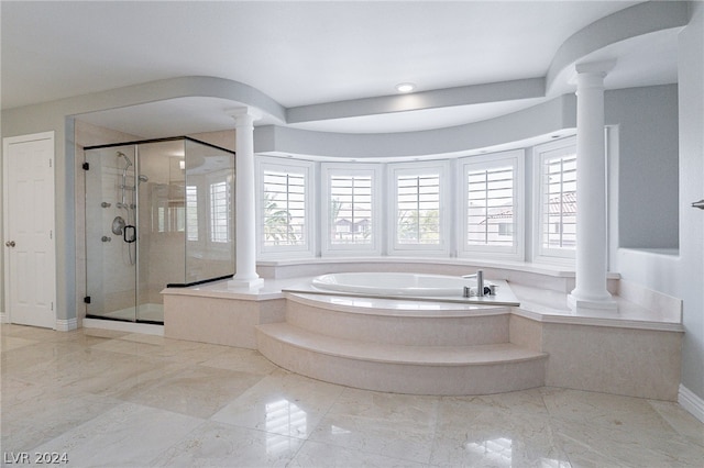 bathroom with shower with separate bathtub and ornate columns