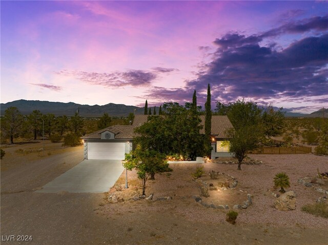 view of front facade with a mountain view and a garage