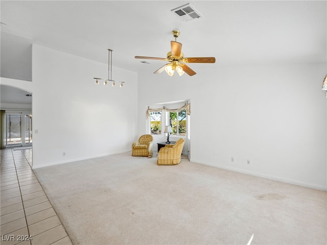 living area with ceiling fan and carpet floors