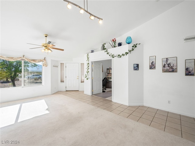 unfurnished living room featuring ceiling fan and light carpet