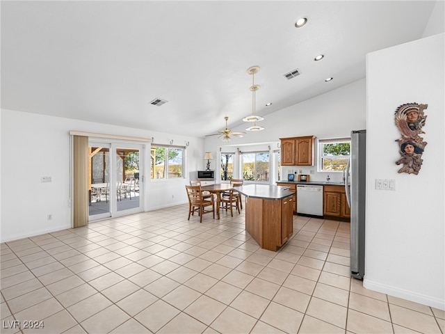 kitchen with light tile patterned floors, stainless steel fridge, ceiling fan, dishwasher, and vaulted ceiling