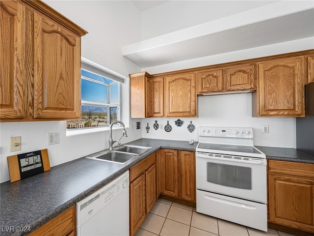 kitchen featuring sink, white appliances, and light tile patterned floors