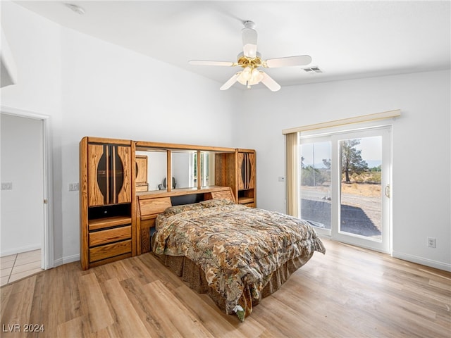 bedroom with vaulted ceiling, ceiling fan, light hardwood / wood-style floors, and access to outside