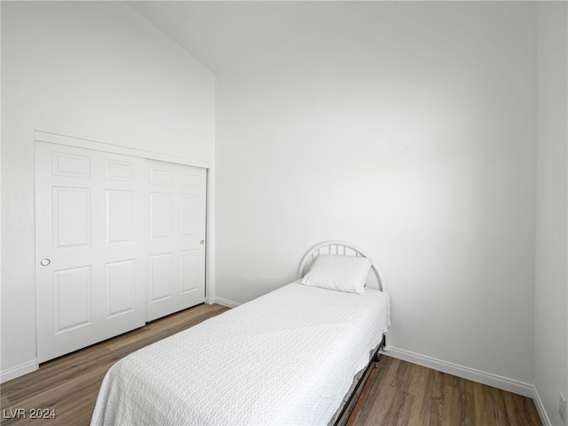 bedroom with a closet and dark hardwood / wood-style floors