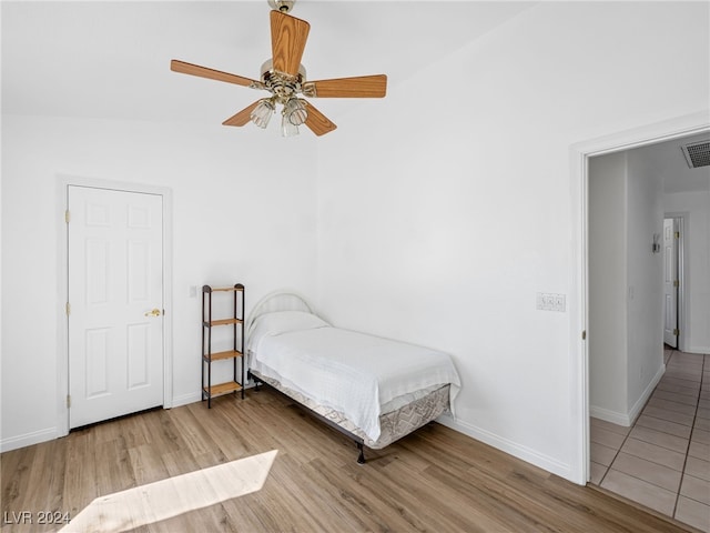 bedroom featuring ceiling fan and light hardwood / wood-style floors