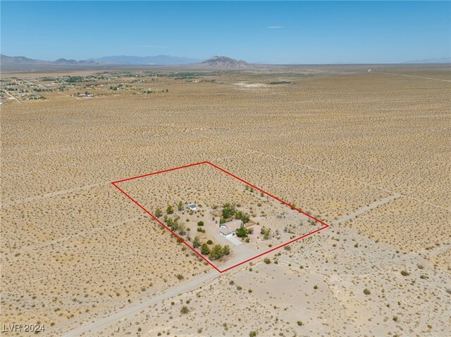 birds eye view of property with a mountain view