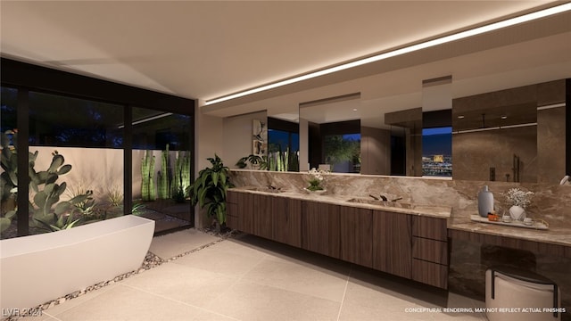 bathroom with tile patterned floors, a tub, and vanity